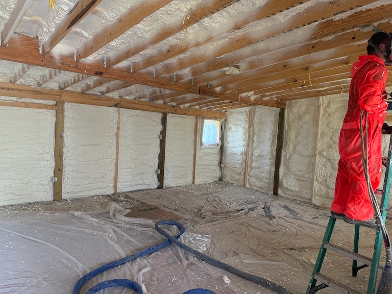 Professional spray foam insulation being applied inside Kentucky home attic by Spray & Save
